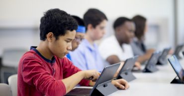 Youths learning digital cyber skills in a computer lab