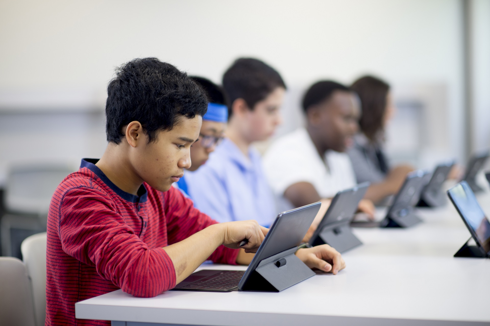 Youths learning digital cyber skills in a computer lab